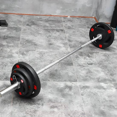 Une barre d'haltérophilie olympique et disque musculation 